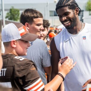 Cleveland Browns quarterback Shedeur Sanders (12) talks to a fan during training camp at CrossCountry Mortgage Campus.