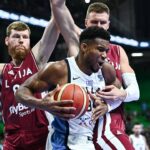 Giannis Antetokounmpo of Greece competes with Davis Bertans and Kristaps Porzingis of Latvia