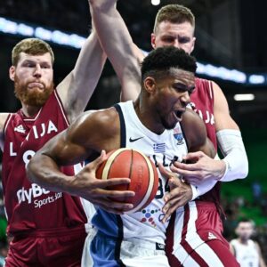 Giannis Antetokounmpo of Greece competes with Davis Bertans and Kristaps Porzingis of Latvia