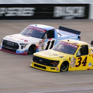 NASCAR Truck Series driver Corey Heim (11) and Layne Riggs (34) race during the Rackley Roofing 200 at Nashville Superspeedway in Lebanon, Tenn., Friday, May 30, 2025.