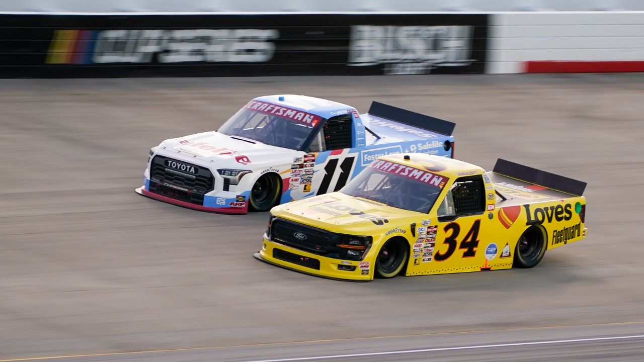 NASCAR Truck Series driver Corey Heim (11) and Layne Riggs (34) race during the Rackley Roofing 200 at Nashville Superspeedway in Lebanon, Tenn., Friday, May 30, 2025.