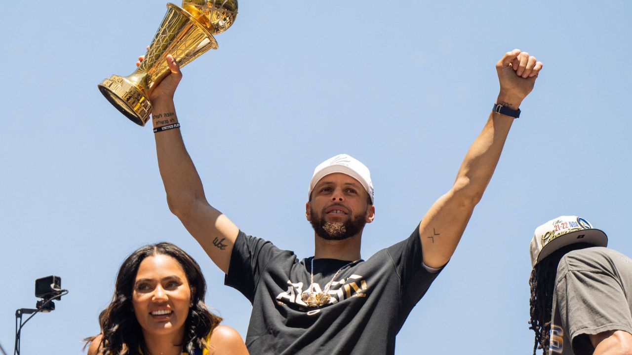 Ayesha Curry and Steph Curry celebrate on a float during the Golden State Warriors Championship Parade in San Francisco, California