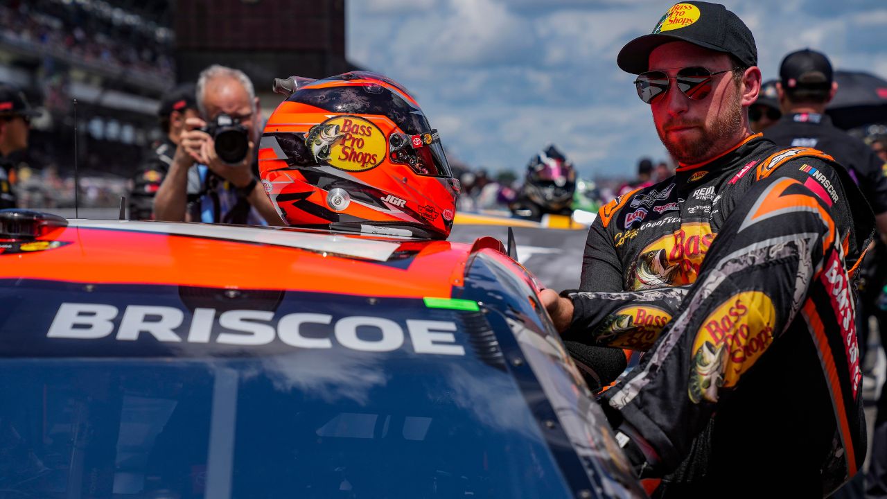 NASCAR Cup Series driver Chase Briscoe (19) climbs into his car Sunday, July 27, 2025, ahead of the Brickyard 400 at Indianapolis Motor Speedway.