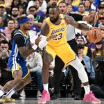Oct 15, 2024; Las Vegas, Nevada, USA; Golden State Warriors guard Gary Payton II (0) defends against Los Angeles Lakers forward LeBron James (23) in the first quarter during a preseason game at T-Mobile Arena