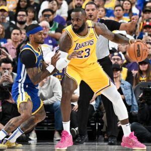 Oct 15, 2024; Las Vegas, Nevada, USA; Golden State Warriors guard Gary Payton II (0) defends against Los Angeles Lakers forward LeBron James (23) in the first quarter during a preseason game at T-Mobile Arena