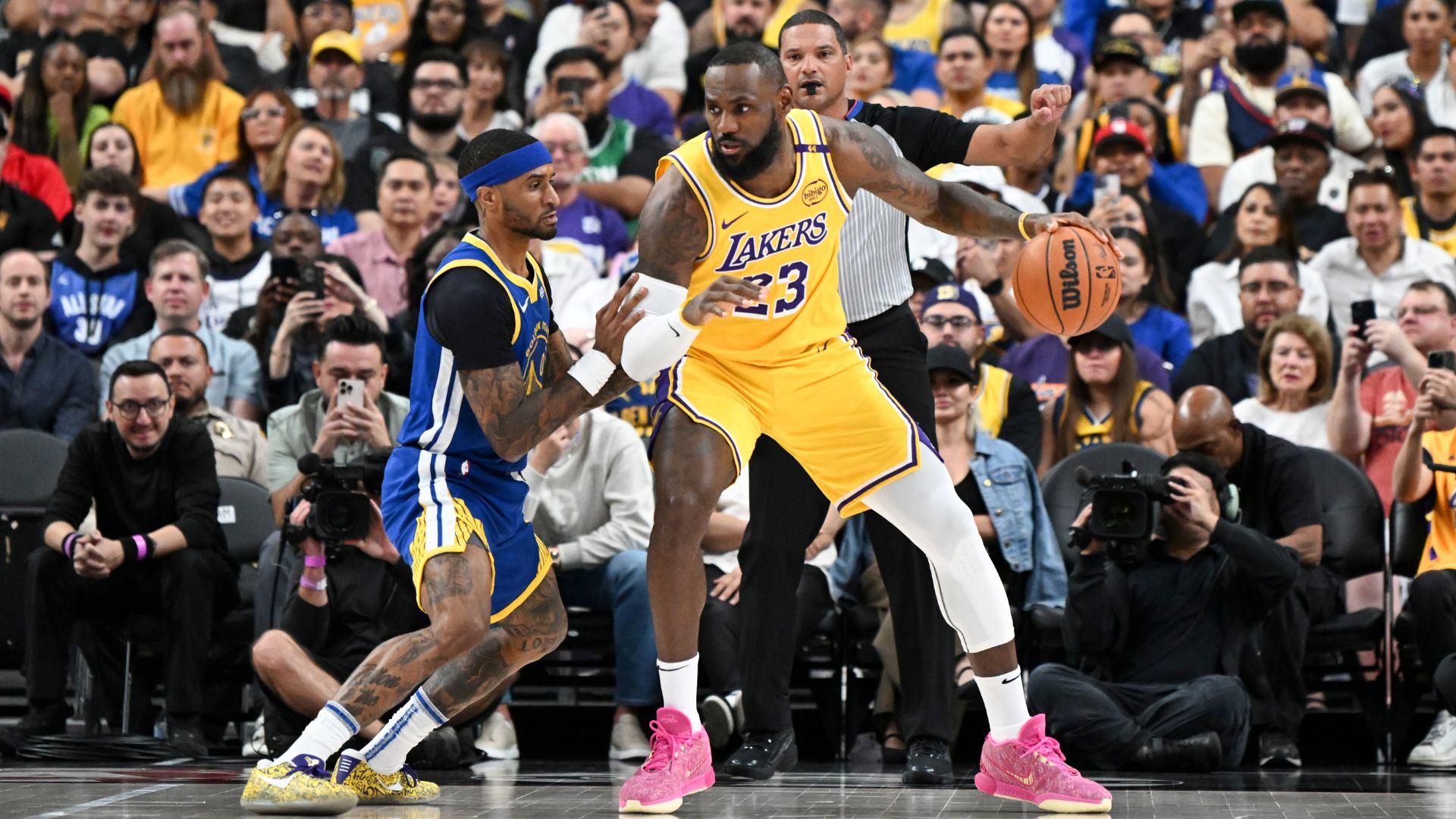 Oct 15, 2024; Las Vegas, Nevada, USA; Golden State Warriors guard Gary Payton II (0) defends against Los Angeles Lakers forward LeBron James (23) in the first quarter during a preseason game at T-Mobile Arena