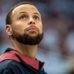 Golden State Warriors guard Stephen Curry (30) looks on from the bench against the Minnesota Timberwolves in the second half during game two of the second round for the 2025 NBA Playoffs at Target Center.