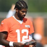 Cleveland Browns quarterback Shedeur Sanders (12) looks at a play sheet during training camp at CrossCountry Mortgage Campus.
