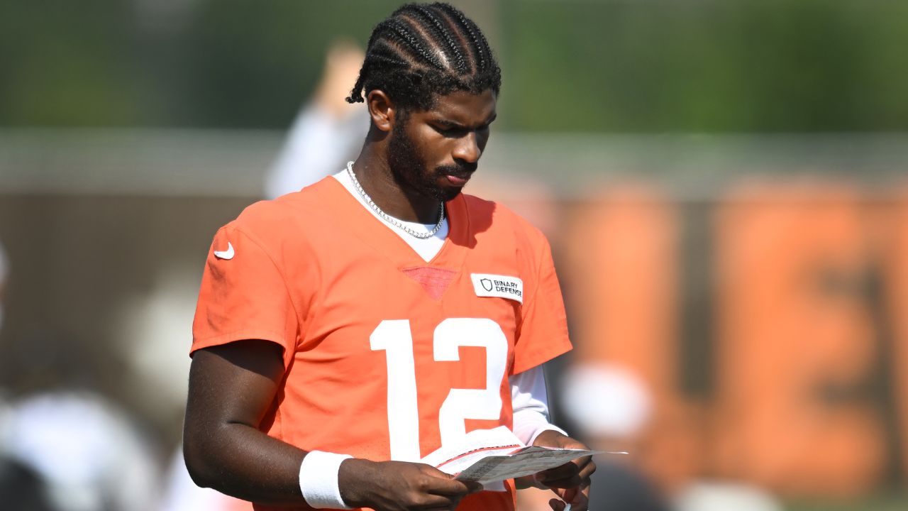 Cleveland Browns quarterback Shedeur Sanders (12) looks at a play sheet during training camp at CrossCountry Mortgage Campus.