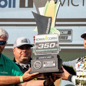 William Byron (24) raises a trophy after the NASCAR Cup Series Iowa Corn 350 on Aug. 3, 2025, at Iowa Speedway in Newton, Iowa. Byron (24) finished the race first.