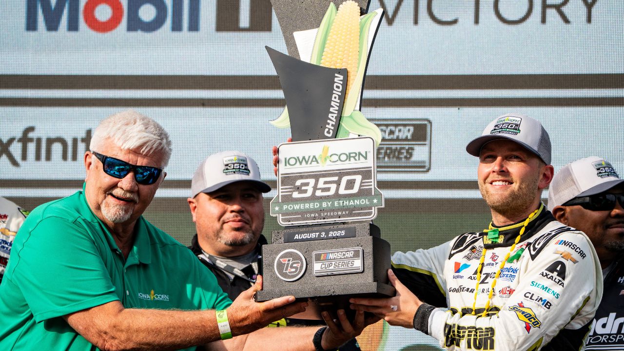 William Byron (24) raises a trophy after the NASCAR Cup Series Iowa Corn 350 on Aug. 3, 2025, at Iowa Speedway in Newton, Iowa. Byron (24) finished the race first.