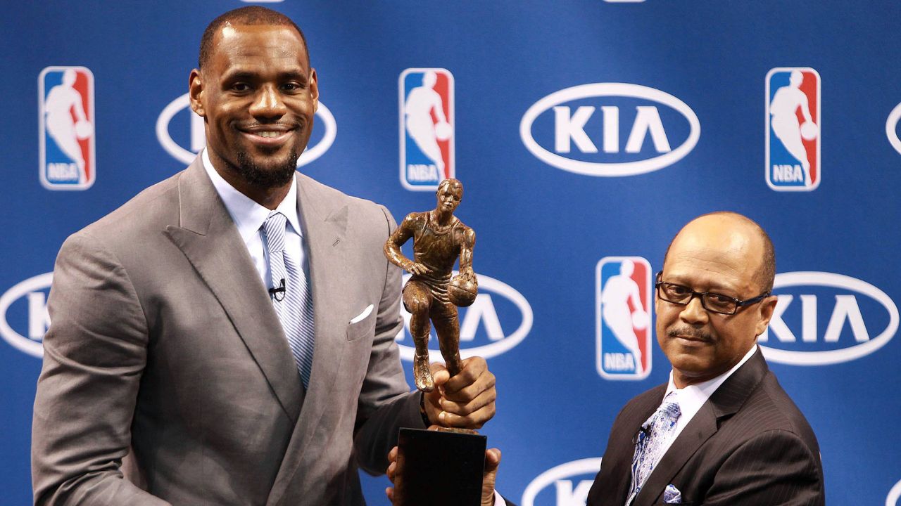The Miami Heat s Lebron James attends a press conference for his being named the NBA s Most Valuable Player at American Airlines Arena in Miami, Florida, Saturday, May 12, 2012. Percy D. Vaughn, Regional Director for Kia Motor America, holds the MVP trophy with James.