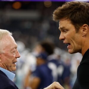Dallas Cowboys owner Jerry Jones (L) talks to former NFL player Tom Brady (R) before the game against the Las Vegas Raiders at AT&T Stadium.