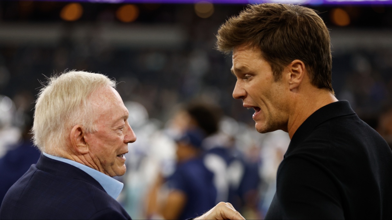 Dallas Cowboys owner Jerry Jones (L) talks to former NFL player Tom Brady (R) before the game against the Las Vegas Raiders at AT&T Stadium.