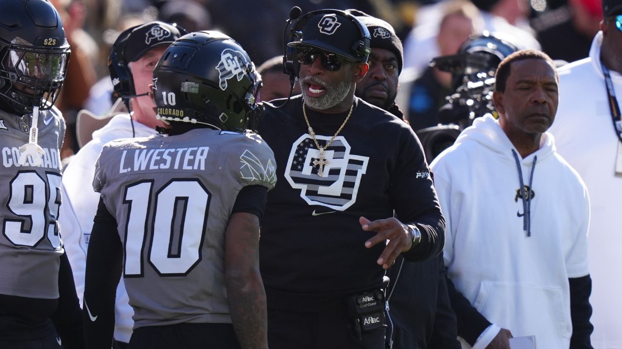 Colorado Buffaloes head coach Deion Sanders congratulates wide receiver LaJohntay Wester (10) for his punt return for a touchdown in the first quarter against the Utah Utes at Folsom Field.