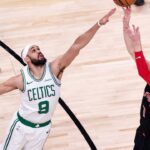 Gradey Dick (1) of Toronto Raptors in action against Derrick White (9) of Boston Celtics during the NBA