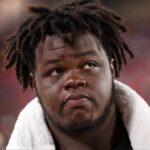 Tampa Bay Buccaneers defensive tackle Desmond Watson (56) looks on from the bench during a preseason game against the Buffalo Bills at Raymond James Stadium.