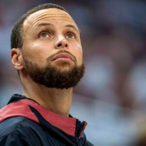Golden State Warriors guard Stephen Curry (30) looks on from the bench against the Minnesota Timberwolves in the second half during game two of the second round for the 2025 NBA Playoffs at Target Center.