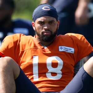 Chicago Bears quarterback Caleb Williams (18) sits on the field during joint training camp practice with the Miami Dolphins ahead of Sunday's preseason opener.