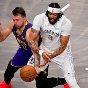 Apr 9, 2025; Dallas, Texas, USA; Los Angeles Lakers guard Luka Doncic (77) knocks the ball away from Dallas Mavericks forward Anthony Davis (3) during the first quarter at the American Airlines Center.