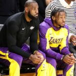 Los Angeles Lakers forward LeBron James (23) and son Los Angeles Lakers guard Bronny James (9) watch from the bench during the Minnesota Timberwolves vs Los Angeles Lakers game