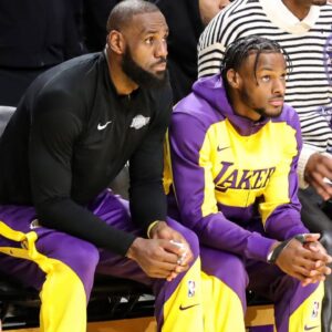 Los Angeles Lakers forward LeBron James (23) and son Los Angeles Lakers guard Bronny James (9) watch from the bench during the Minnesota Timberwolves vs Los Angeles Lakers game