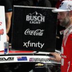 NASCAR Cup Series driver Shane Van Gisbergen applies the winner’s sticker to his car in victory lane after winning the Go Bowling at The Glen at Watkins Glen International.