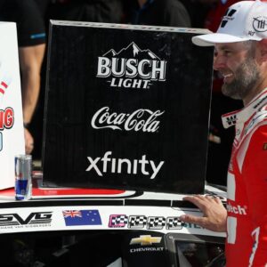NASCAR Cup Series driver Shane Van Gisbergen applies the winner’s sticker to his car in victory lane after winning the Go Bowling at The Glen at Watkins Glen International.