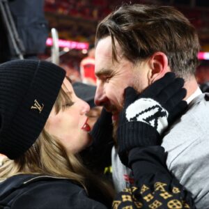 Recording artist Taylor Swift and Kansas City Chiefs tight end Travis Kelce (87) react after the AFC Championship game against the Buffalo Bills at GEHA Field at Arrowhead Stadium.
