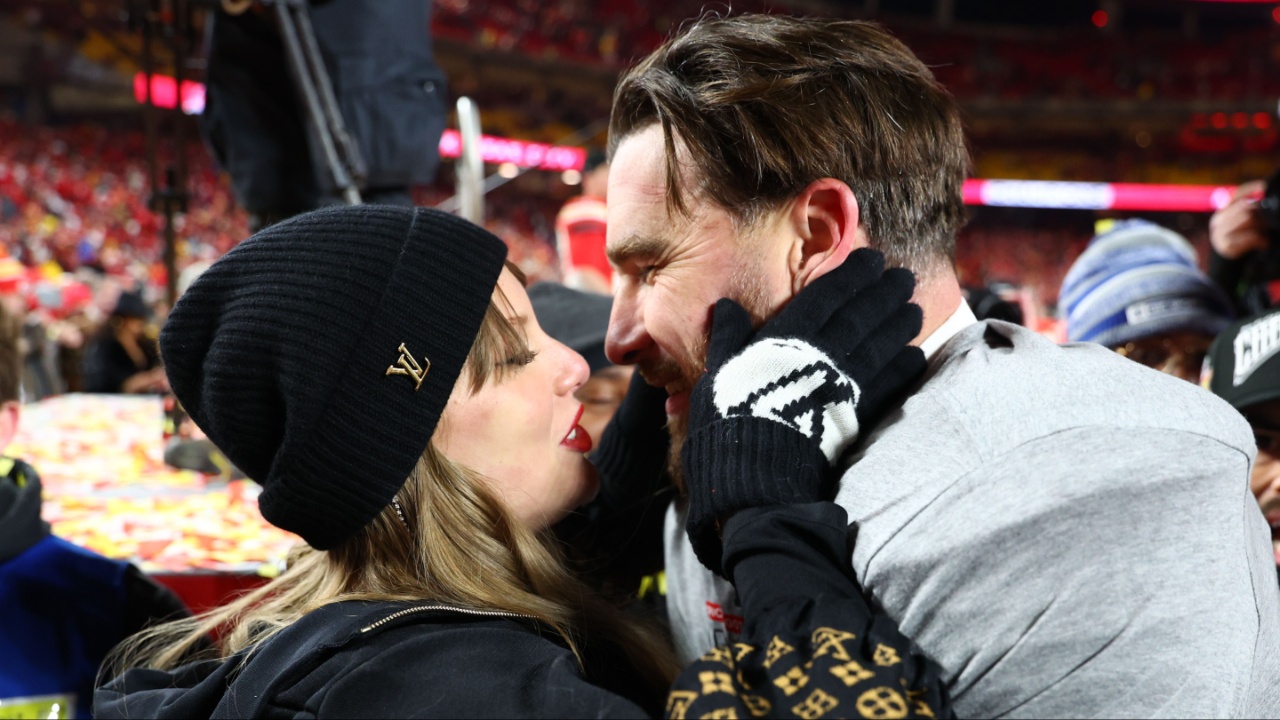 Recording artist Taylor Swift and Kansas City Chiefs tight end Travis Kelce (87) react after the AFC Championship game against the Buffalo Bills at GEHA Field at Arrowhead Stadium.