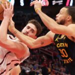 Feb 13, 2025; Houston, Texas, USA; Houston Rockets center Alperen Sengun (28) grabs a rebound against Golden State Warriors guard Stephen Curry (30) in the first half at Toyota Center.
