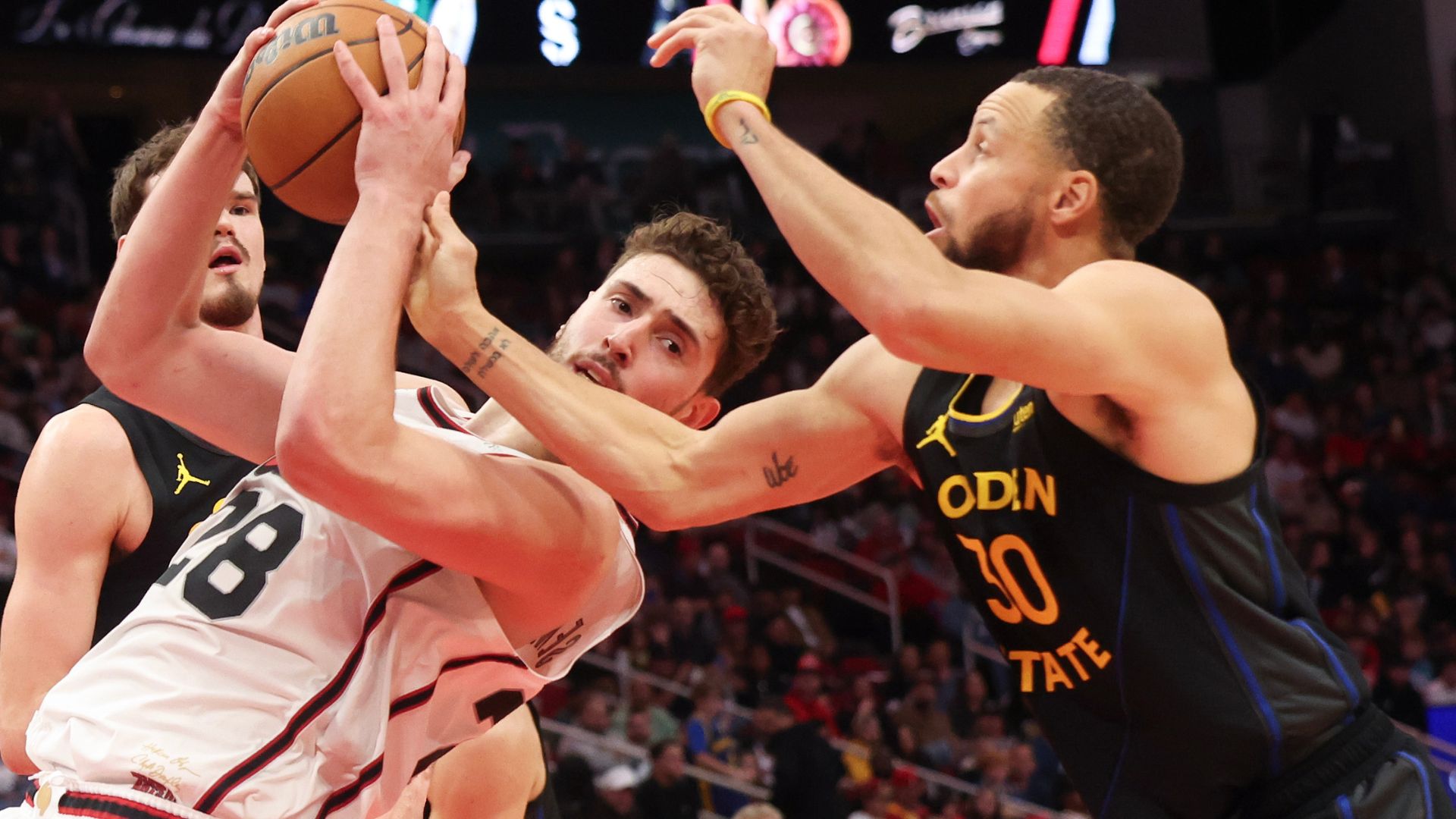Feb 13, 2025; Houston, Texas, USA; Houston Rockets center Alperen Sengun (28) grabs a rebound against Golden State Warriors guard Stephen Curry (30) in the first half at Toyota Center.