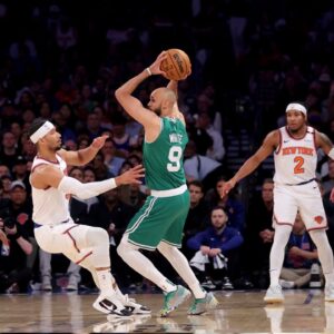 Boston Celtics guard Derrick White (9) controls the ball against New York Knicks guard Josh Hart (3) and center Mitchell Robinson (23) and guard Miles McBride (2) during the second quarter of game six in the second round of the 2025 NBA Playoffs at Madison Square Garden.