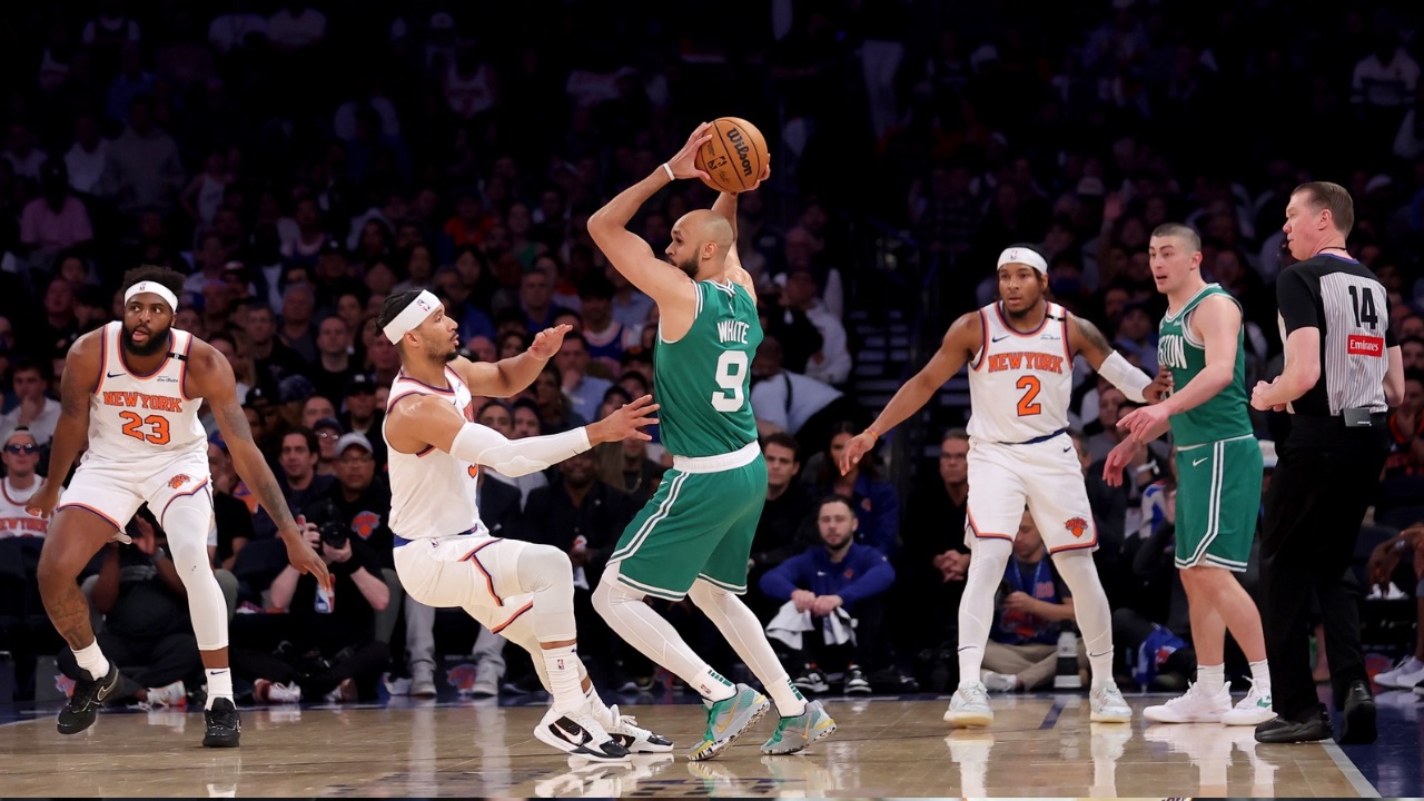 Boston Celtics guard Derrick White (9) controls the ball against New York Knicks guard Josh Hart (3) and center Mitchell Robinson (23) and guard Miles McBride (2) during the second quarter of game six in the second round of the 2025 NBA Playoffs at Madison Square Garden.