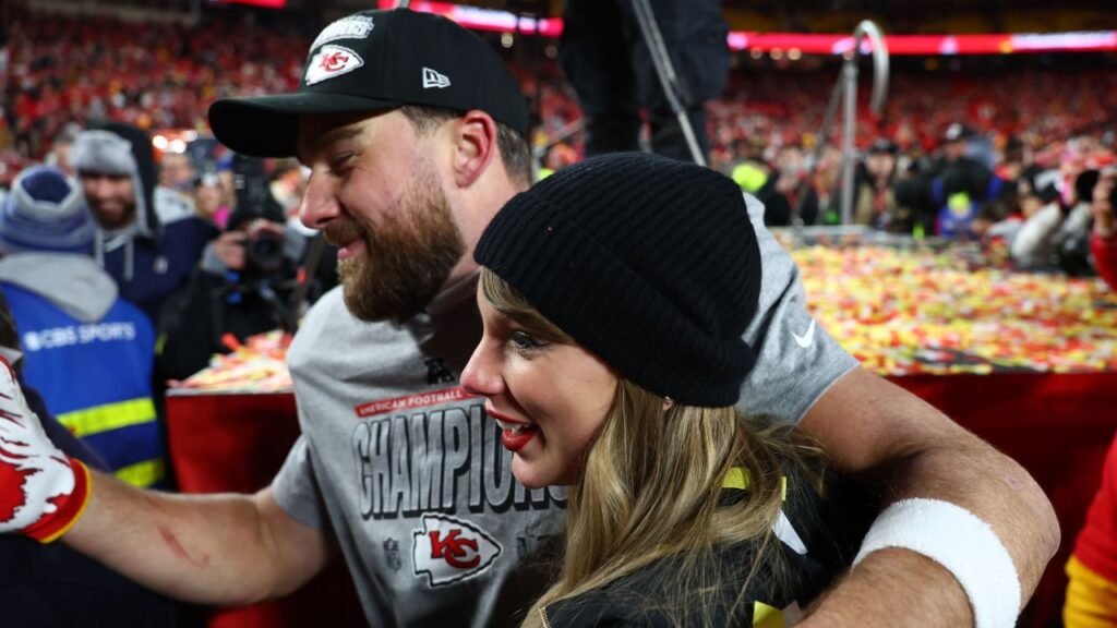 Recording artist Taylor Swift and Kansas City Chiefs tight end Travis Kelce (87) react after the AFC Championship game against the Buffalo Bills at GEHA Field at Arrowhead Stadium.