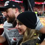 Recording artist Taylor Swift and Kansas City Chiefs tight end Travis Kelce (87) react after the AFC Championship game against the Buffalo Bills at GEHA Field at Arrowhead Stadium.