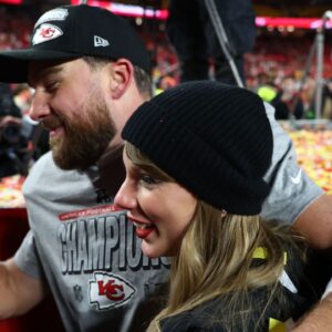 Recording artist Taylor Swift and Kansas City Chiefs tight end Travis Kelce (87) react after the AFC Championship game against the Buffalo Bills at GEHA Field at Arrowhead Stadium.