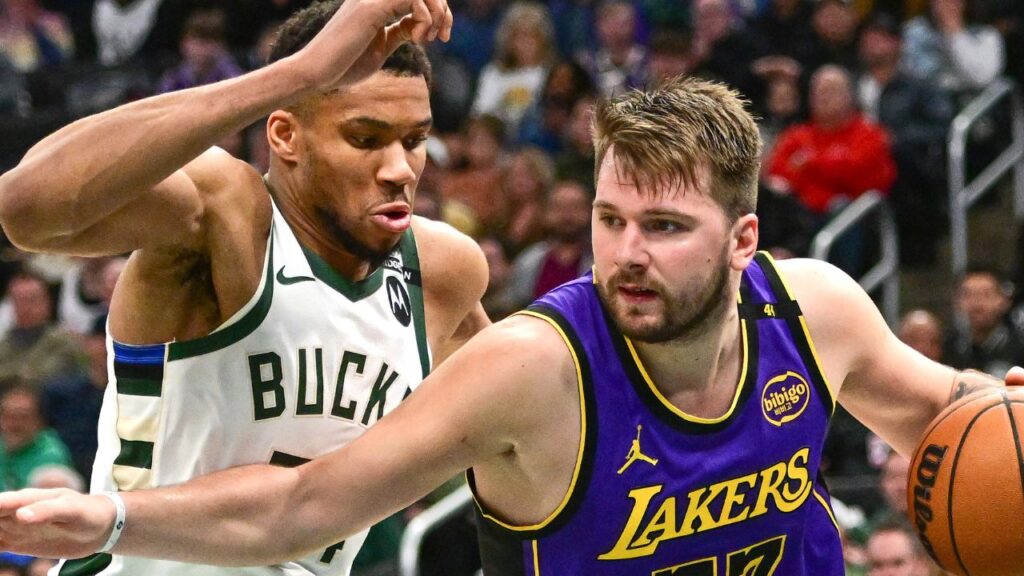 Los Angeles Lakers guard Luka Doncic (77) drives to the basket against Milwaukee Bucks forward Giannis Antetokounmpo (34) in the third quarter at Fiserv Forum.