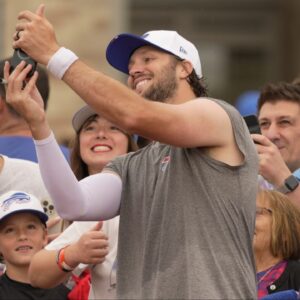 Josh Allen uses a fan's phone to take a selfie with them after Bills Training Camp at St. John Fisher University in Pittsford on July 31, 2025.