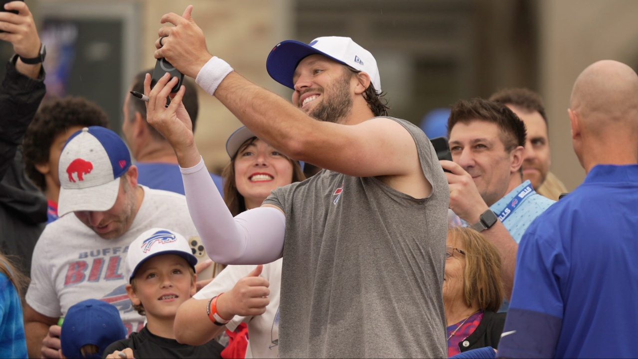 Josh Allen uses a fan's phone to take a selfie with them after Bills Training Camp at St. John Fisher University in Pittsford on July 31, 2025.