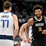 Memphis Grizzlies guard Marcus Smart (36) smiles after scoring against Dallas Mavericks guard Luka Doncic (77) during the first quarter at the American Airlines Center.