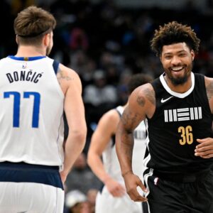 Memphis Grizzlies guard Marcus Smart (36) smiles after scoring against Dallas Mavericks guard Luka Doncic (77) during the first quarter at the American Airlines Center.