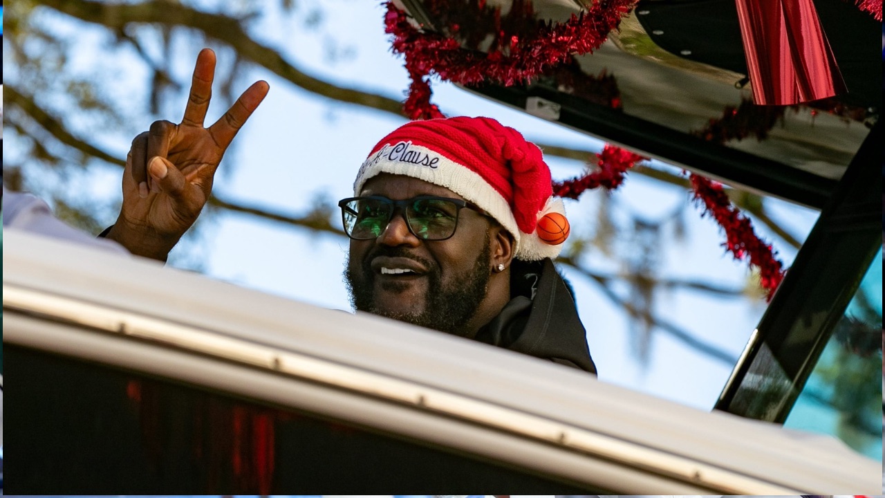 Basketball great Shaquille O’Neal waves during A Very GNV Holiday Parade at Downtown in Gainesville, FL on Saturday, December 7, 2024. The annual event attracts thousands of residents and features every thing from the grinch to the Fighting Gator Marching band. Shaquille O’Neal was the grand marshal and Santa waved from a firetruck at the end.