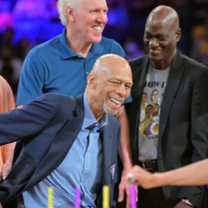 Byron Scott, Bill Walton, Michael Cooper and Jamal Wilkes look on as birthday candles are lit to celebrate Los Angeles Lakers Hall of Famers Kareem Abdul-Jabbar 75th birthday during halftime during the game between the Los Angeles Lakers and the Oklahoma City Thunder at Crypto.com Arena.