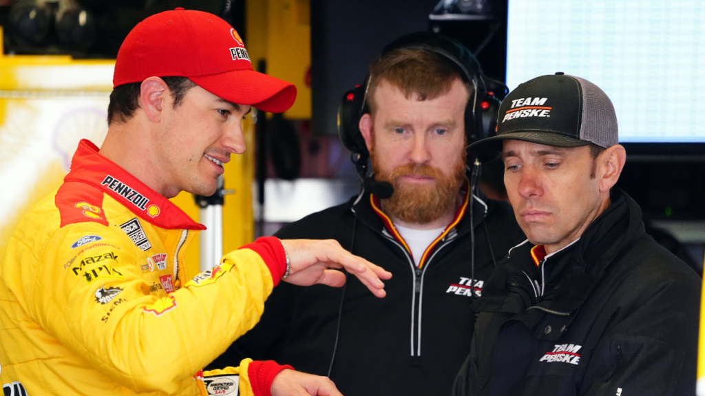 Feb 18, 2023; Daytona Beach, Florida, USA; NASCAR Cup Series driver Joey Logano (22) talks with crew chief Paul Wolfe in his garage stall following practice for the Daytona 500 at Daytona International Speedway. Mandatory Credit: John David Mercer-Imagn Images