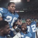 Detroit Lions running back Barry Sanders is carried on the shoulders of teammates after reaching the 2,000-yard milestone in 1997.