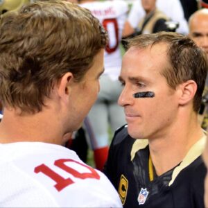 New York Giants quarterback Eli Manning (10) and New Orleans Saints quarterback Drew Brees (9) talk after the game at the Mercedes-Benz Superdome. New Orleans won 52-49.