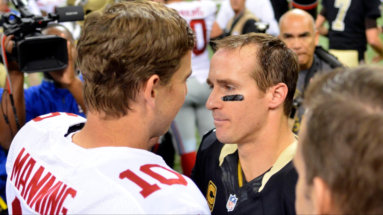 New York Giants quarterback Eli Manning (10) and New Orleans Saints quarterback Drew Brees (9) talk after the game at the Mercedes-Benz Superdome. New Orleans won 52-49.