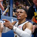 Denver Nuggets guard Russell Westbrook (4) reacts after a play and falling into fans in the second quarter against the Oklahoma City Thunder during game two of the second round for the 2025 NBA Playoffs at Paycom Center.