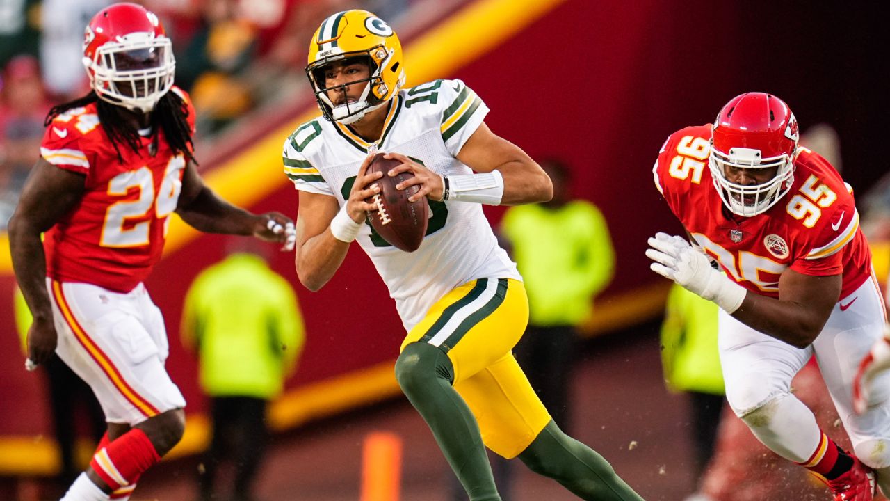 Green Bay Packers quarterback Jordan Love (10) runs past Kansas City Chiefs defensive end Melvin Ingram III (24) and defensive end Chris Jones (95) during the first half at GEHA Field at Arrowhead Stadium.